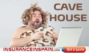 Cave man looking at computer with a surprised look on his face as he finds Cave house insurance in Spain 